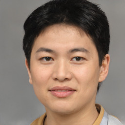 Joyful asian young-adult male with short  brown hair and brown eyes