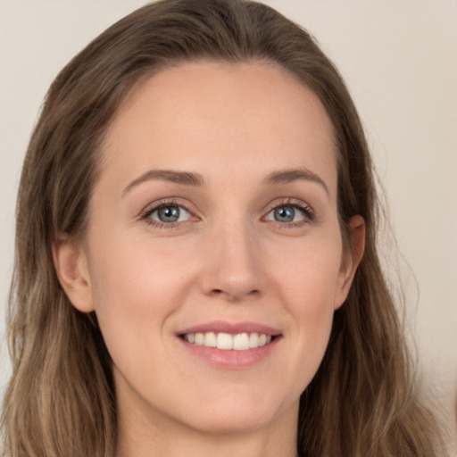 Joyful white young-adult female with long  brown hair and grey eyes