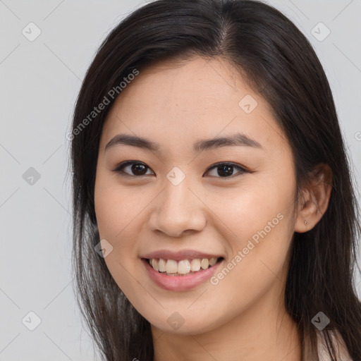 Joyful asian young-adult female with long  brown hair and brown eyes