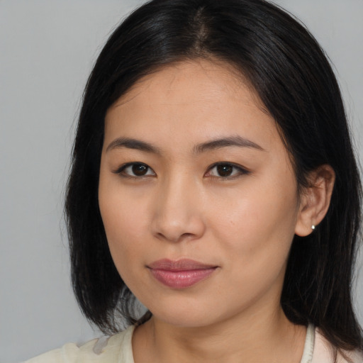 Joyful asian young-adult female with medium  black hair and brown eyes