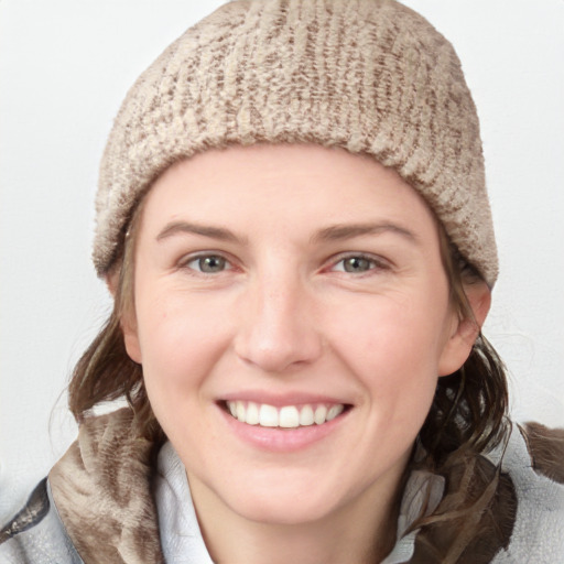 Joyful white young-adult female with medium  brown hair and blue eyes