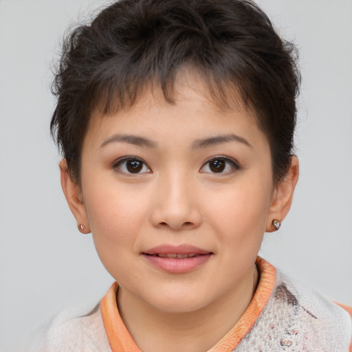 Joyful asian child female with short  brown hair and brown eyes
