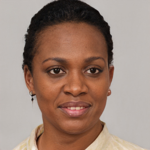 Joyful black young-adult female with short  brown hair and brown eyes