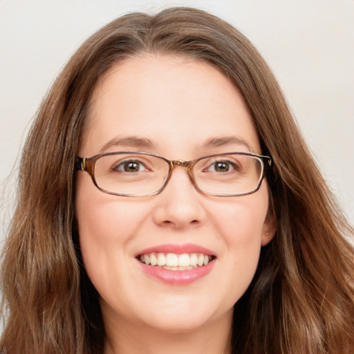 Joyful white young-adult female with long  brown hair and blue eyes