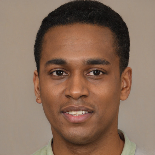 Joyful black young-adult male with short  black hair and brown eyes