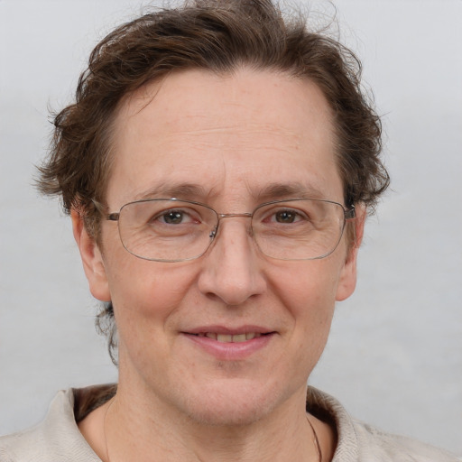 Joyful white middle-aged female with short  brown hair and grey eyes