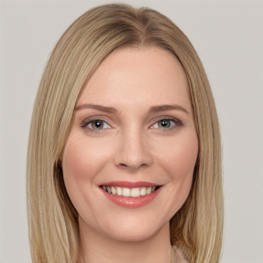 Joyful white young-adult female with long  brown hair and blue eyes