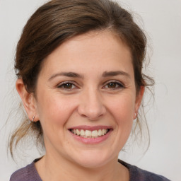 Joyful white adult female with medium  brown hair and brown eyes