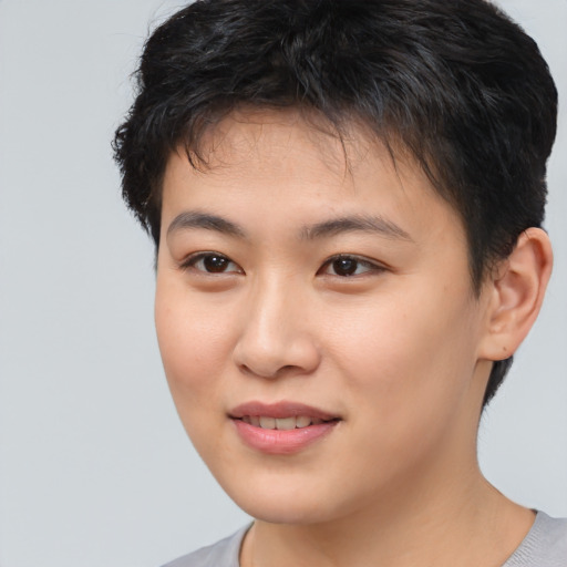Joyful asian young-adult female with short  brown hair and brown eyes