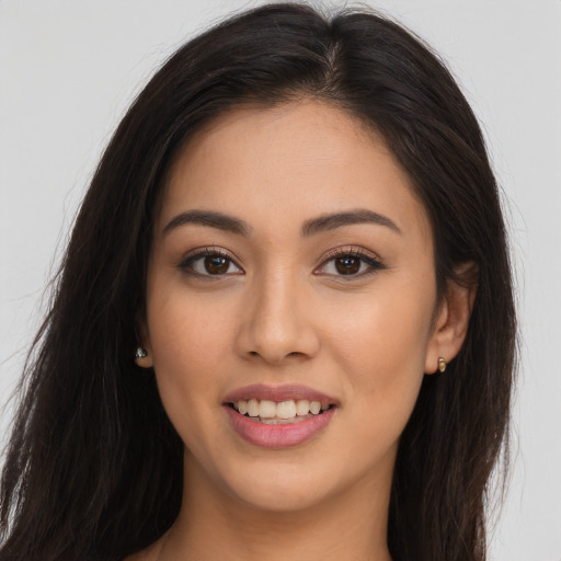 Joyful white young-adult female with long  brown hair and brown eyes