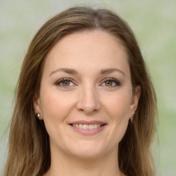 Joyful white young-adult female with long  brown hair and green eyes