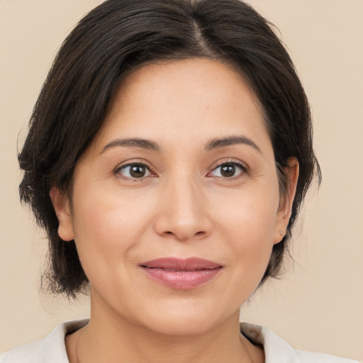 Joyful white adult female with medium  brown hair and brown eyes