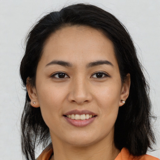 Joyful asian young-adult female with long  brown hair and brown eyes