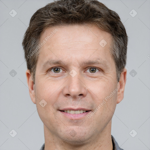 Joyful white adult male with short  brown hair and brown eyes