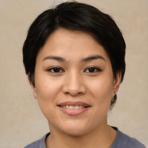 Joyful asian young-adult female with medium  brown hair and brown eyes