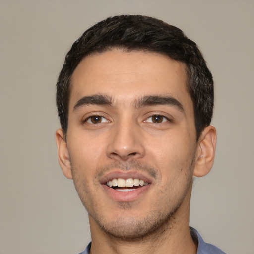 Joyful white young-adult male with short  black hair and brown eyes