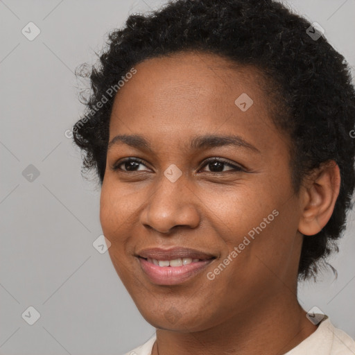 Joyful black young-adult female with short  brown hair and brown eyes