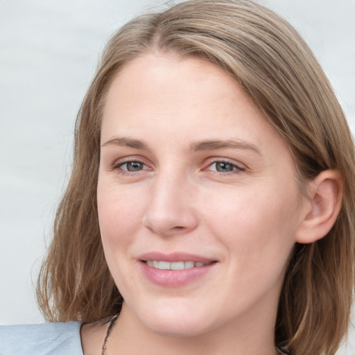 Joyful white young-adult female with medium  brown hair and blue eyes