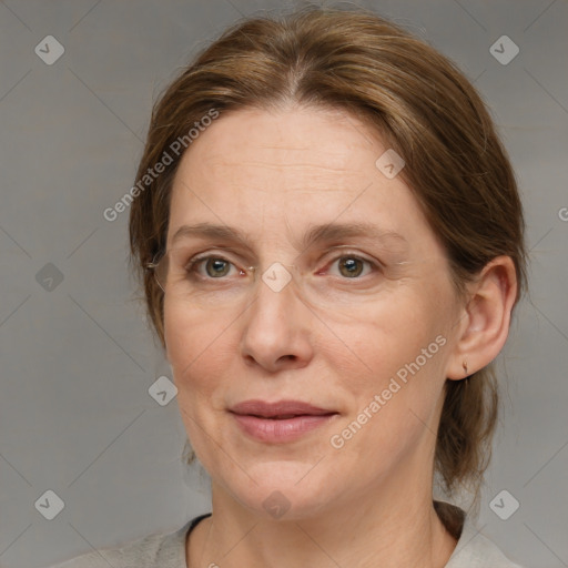 Joyful white adult female with medium  brown hair and blue eyes