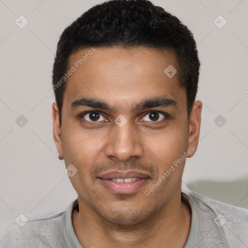 Joyful black young-adult male with short  black hair and brown eyes