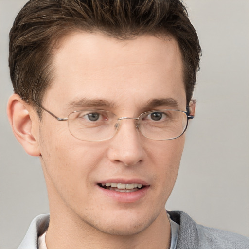 Joyful white adult male with short  brown hair and grey eyes