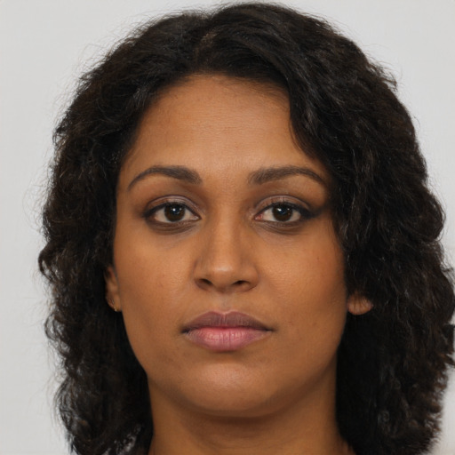 Neutral black young-adult female with long  brown hair and brown eyes