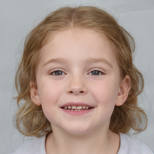 Joyful white child female with medium  brown hair and blue eyes