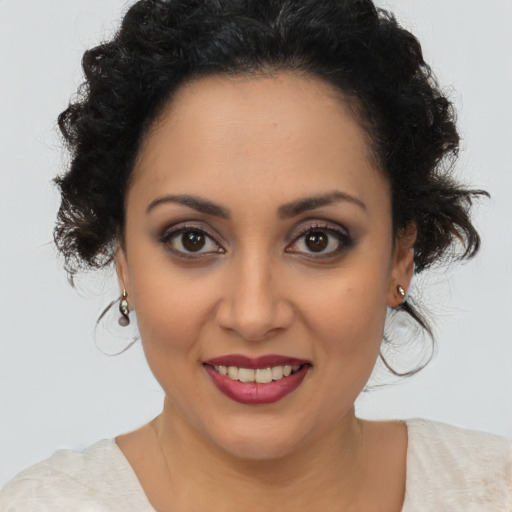 Joyful latino young-adult female with medium  brown hair and brown eyes