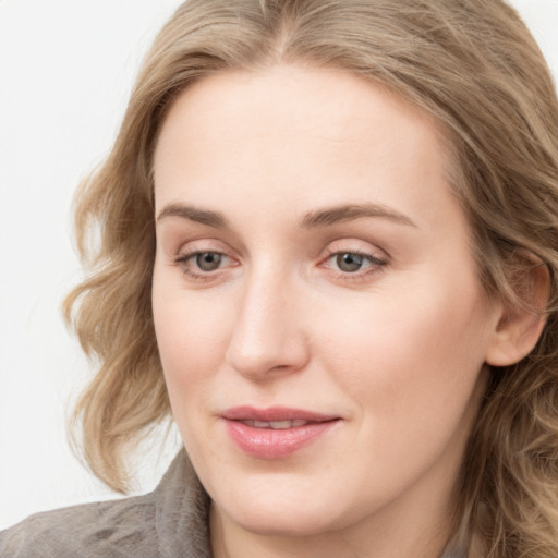 Joyful white young-adult female with medium  brown hair and blue eyes