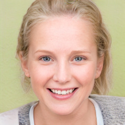 Joyful white young-adult female with medium  brown hair and blue eyes