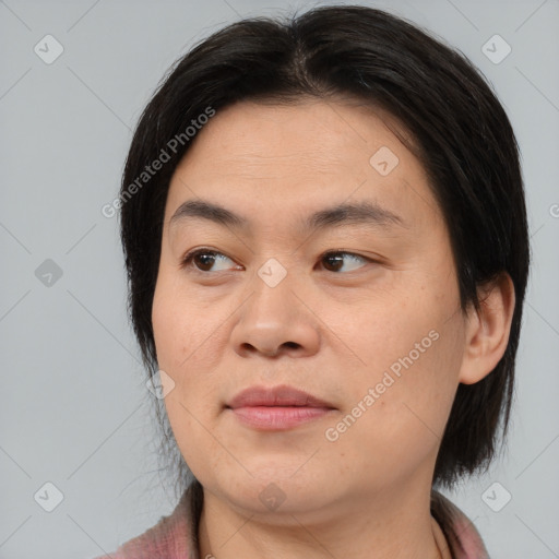 Joyful asian young-adult female with medium  brown hair and brown eyes