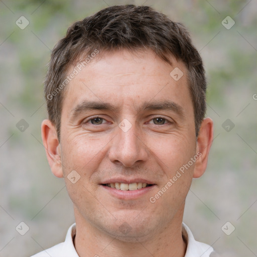 Joyful white adult male with short  brown hair and brown eyes