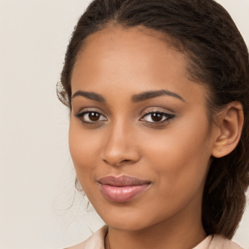 Joyful latino young-adult female with long  brown hair and brown eyes