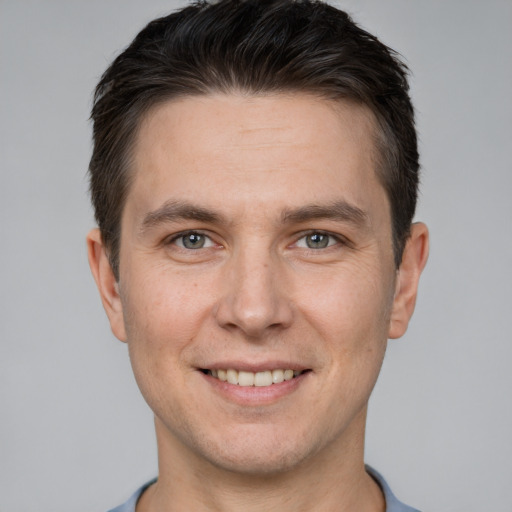 Joyful white adult male with short  brown hair and brown eyes