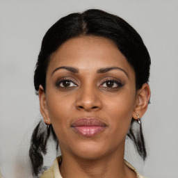 Joyful black young-adult female with medium  black hair and brown eyes