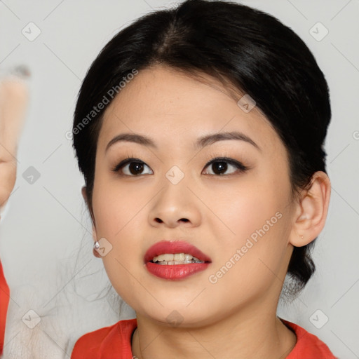 Joyful asian young-adult female with medium  black hair and brown eyes
