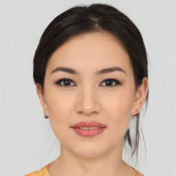 Joyful asian young-adult female with medium  brown hair and brown eyes