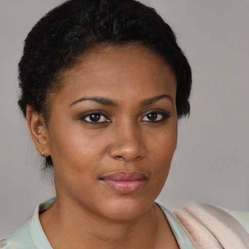 Joyful black young-adult female with short  brown hair and brown eyes