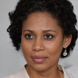 Joyful black adult female with short  brown hair and brown eyes