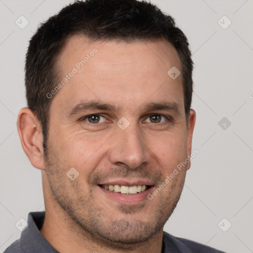 Joyful white adult male with short  brown hair and brown eyes