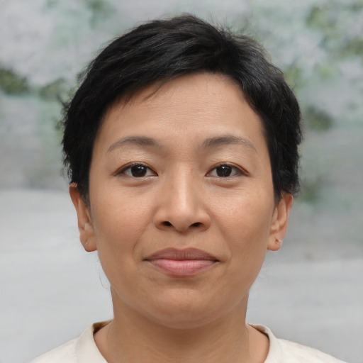 Joyful asian adult female with short  brown hair and brown eyes