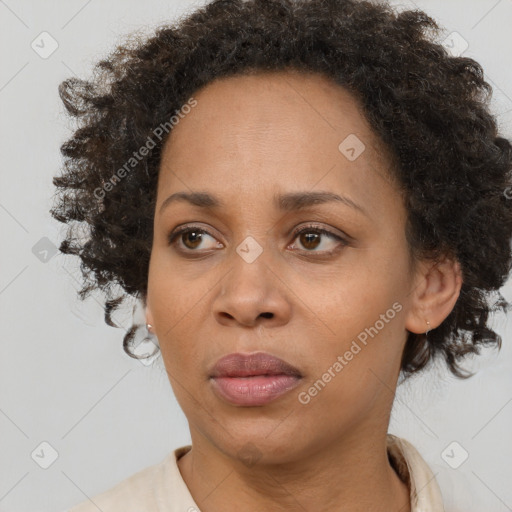 Joyful black adult female with short  brown hair and brown eyes