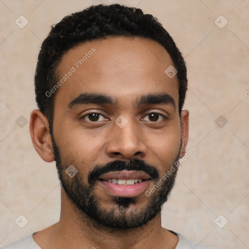 Joyful black young-adult male with short  black hair and brown eyes