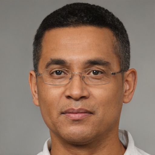 Joyful black adult male with short  black hair and brown eyes