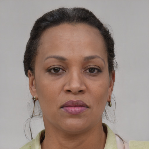Joyful black adult female with short  brown hair and brown eyes