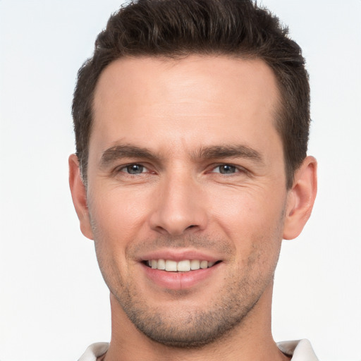 Joyful white young-adult male with short  brown hair and brown eyes