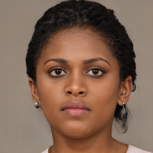 Neutral black young-adult female with medium  brown hair and brown eyes