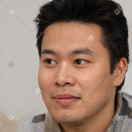 Joyful asian young-adult male with short  brown hair and brown eyes