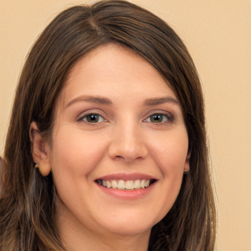 Joyful white young-adult female with long  brown hair and brown eyes