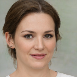 Joyful white young-adult female with medium  brown hair and green eyes